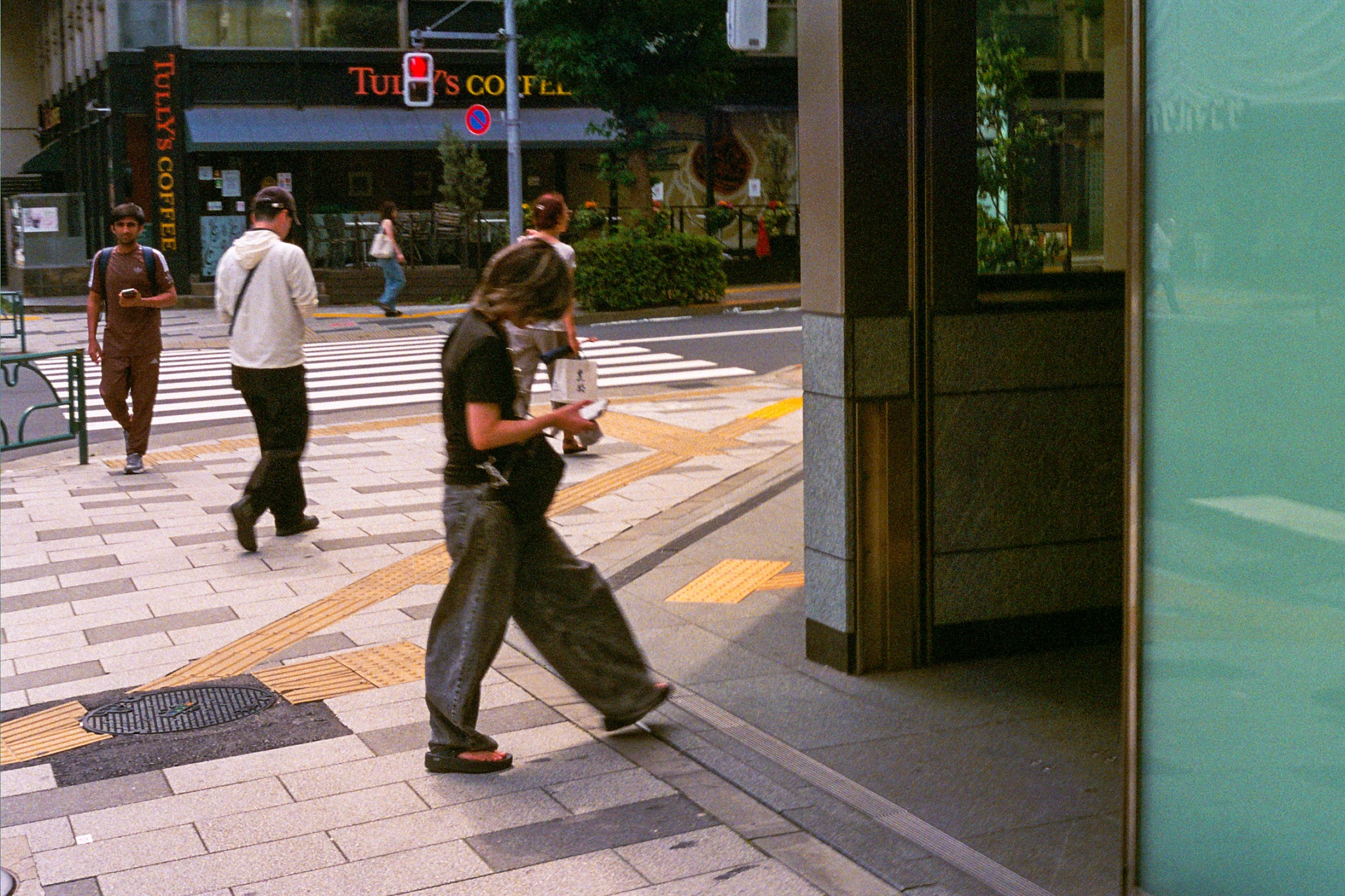 Skateboarders passing through a sunlit street