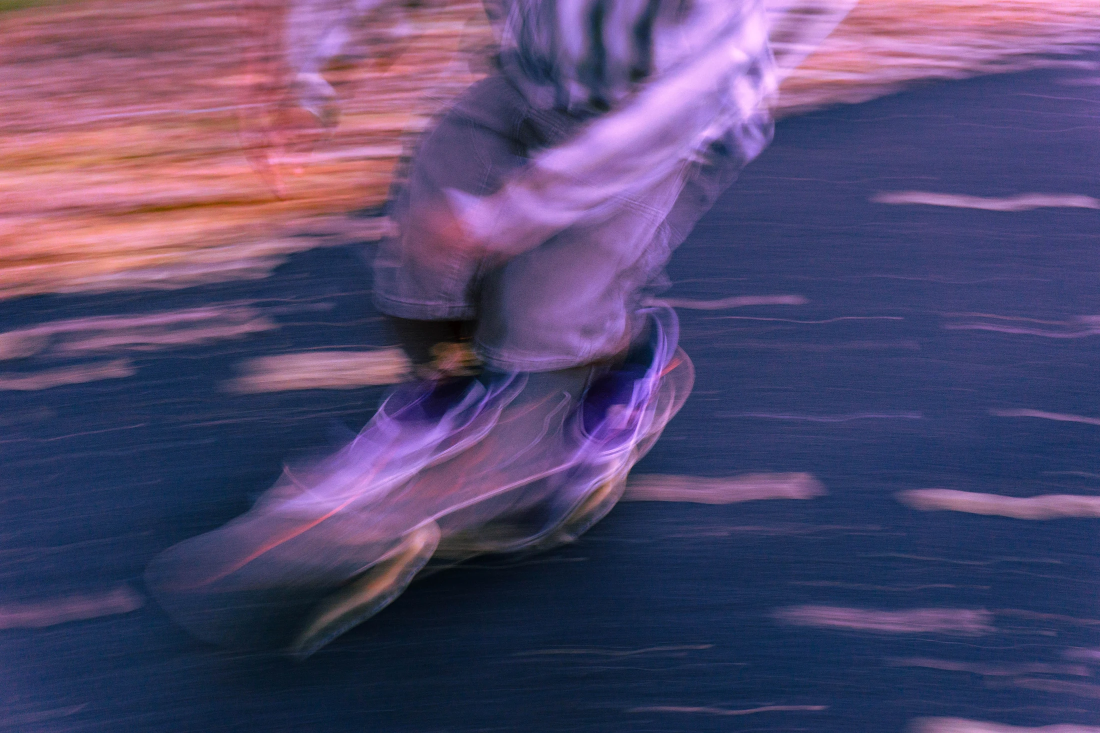 Skateboarding in a wash of violet and pink